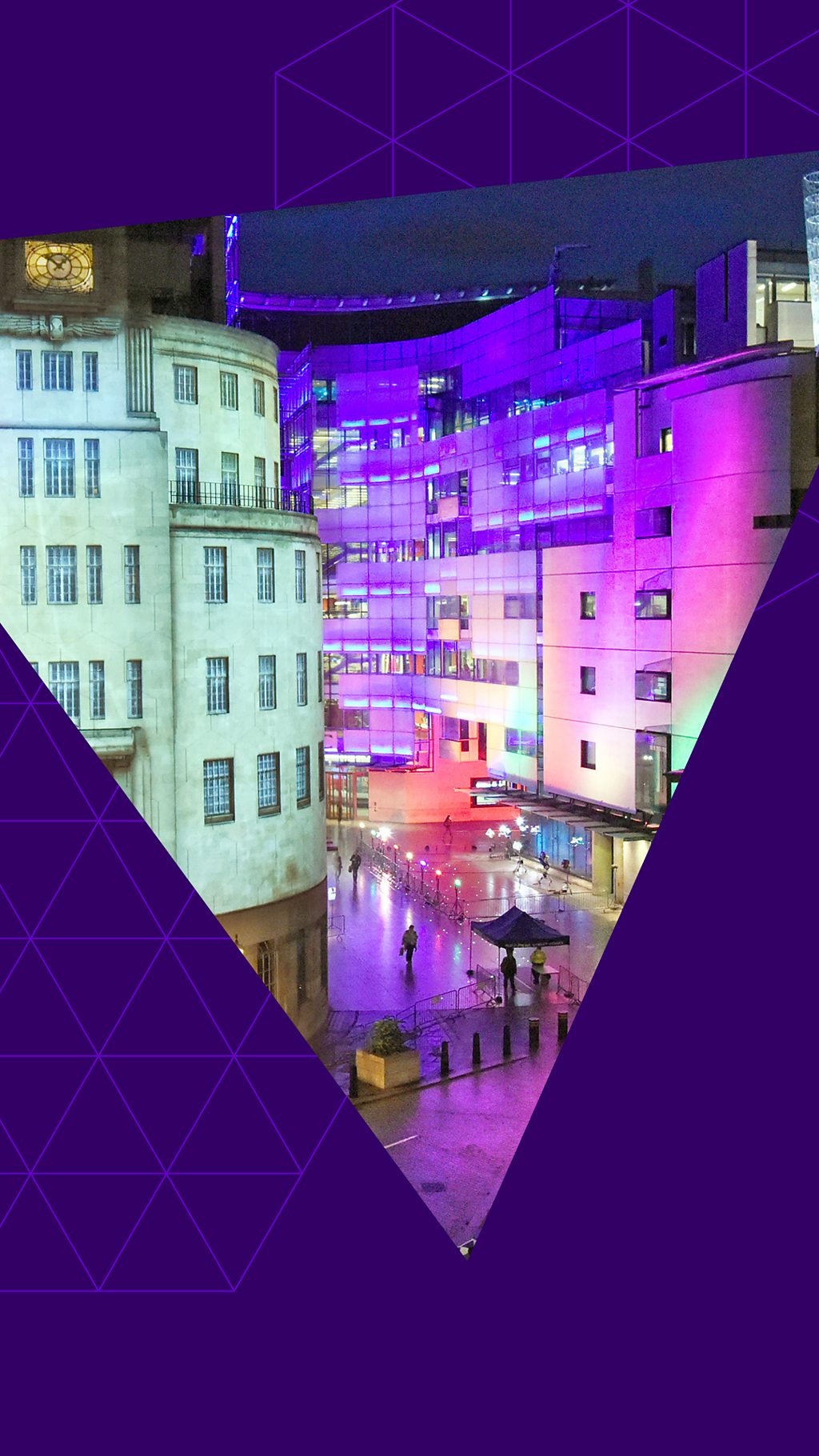 The outside of BBC Broadcasting House lit up in multiple colours for election night with a graphic purple triangle in front