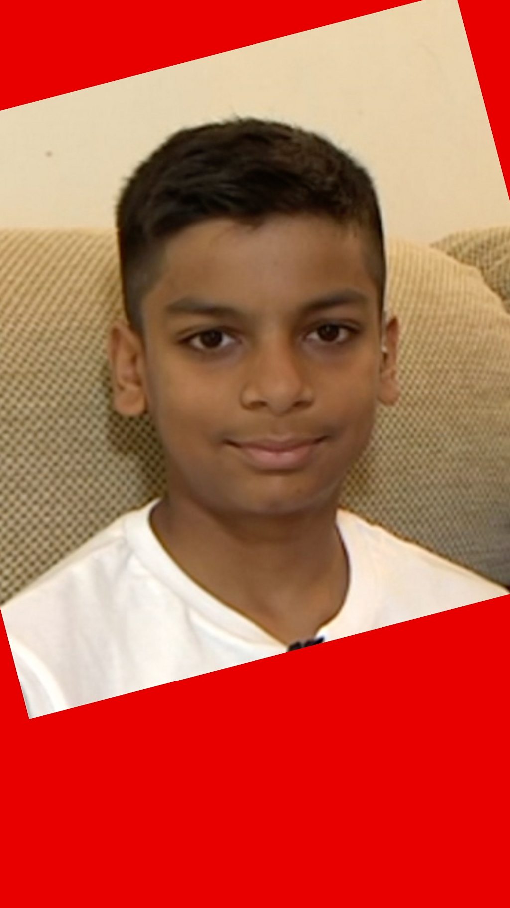 Kautilya looks into the camera smiling. The 10-year-old boy is wearing a white t-shirt