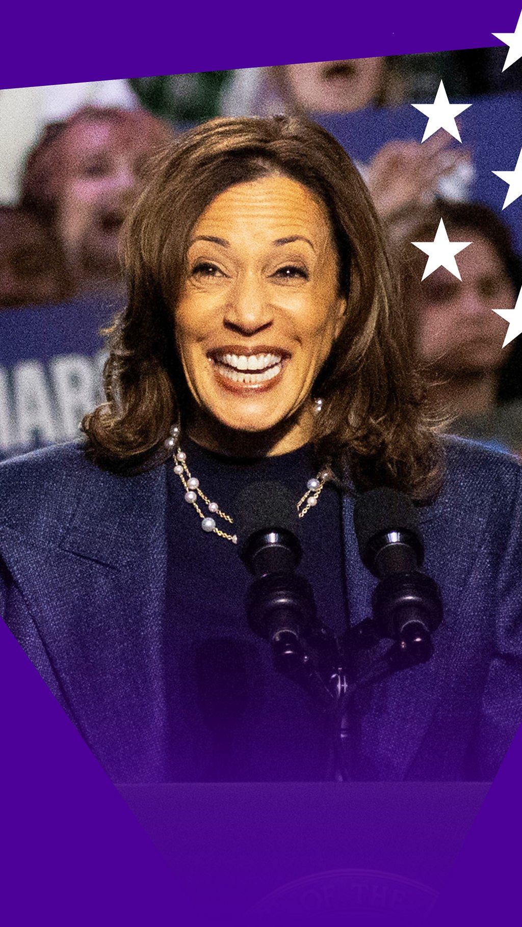 Kamala Harris smiling while behind the lectern at a Michigan rally