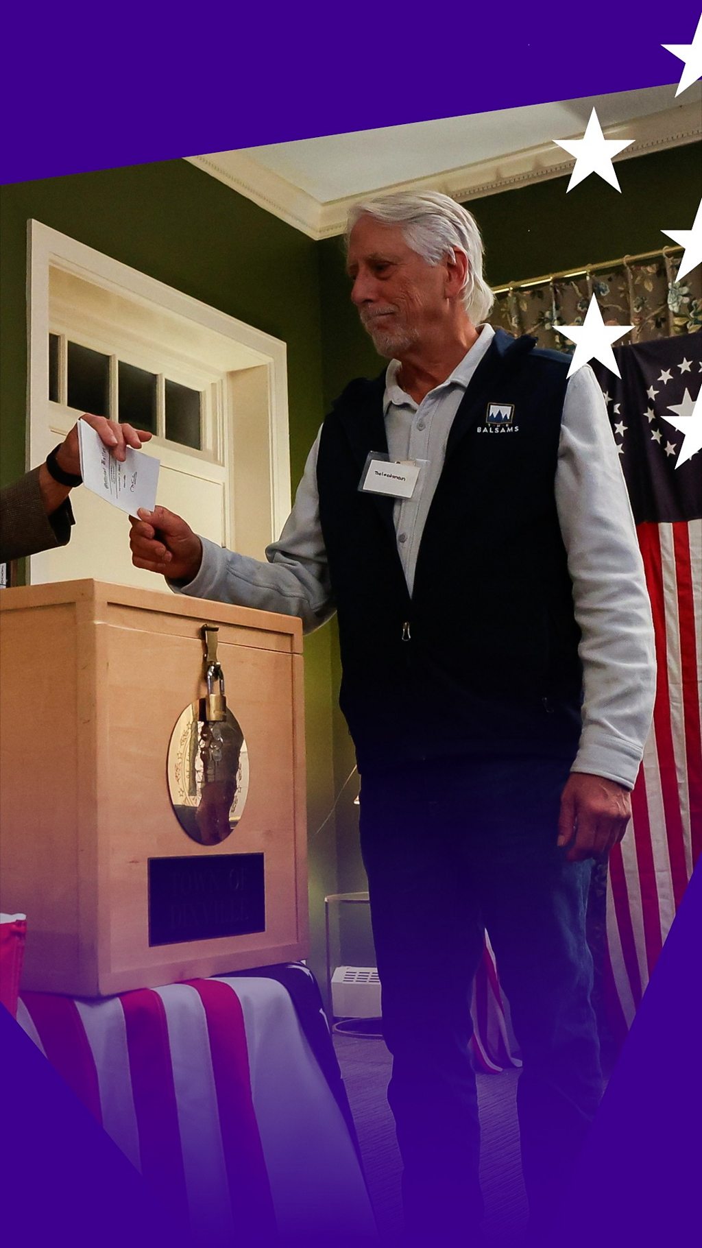 A man holds a ballot form as he votes in Dixville Notch.