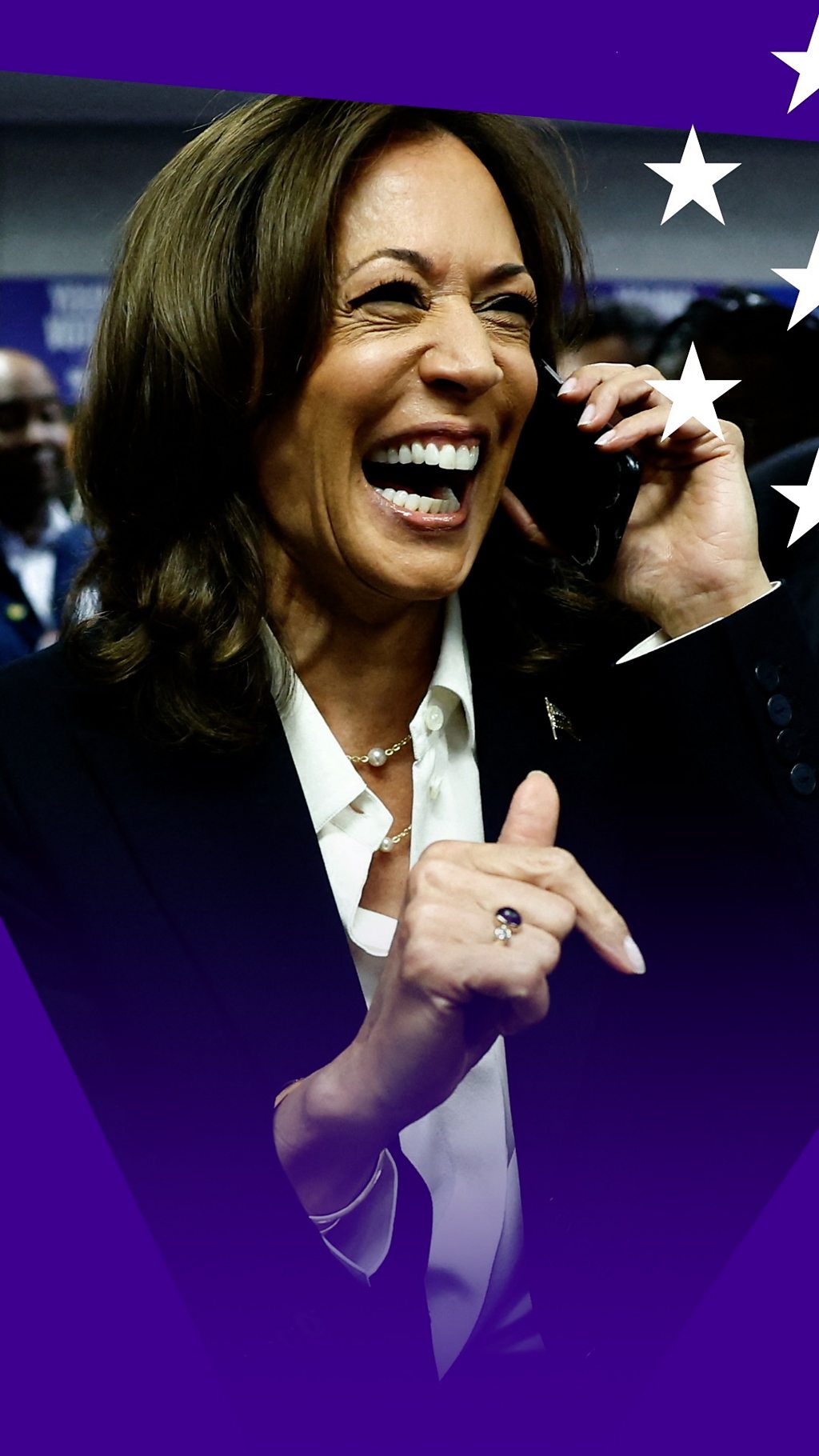 Kamala Harris laughs as she speaks on a mobile phone.