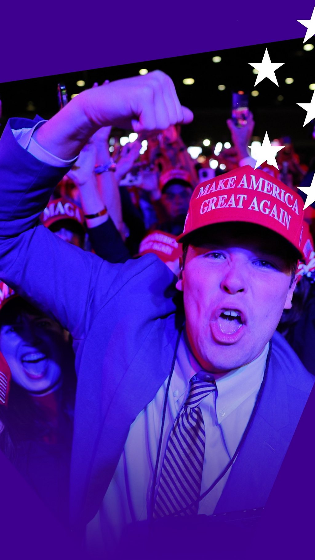 A Trump supporter celebrates - he wears a red hat with 'Make America Great Again' and has his hand in the air