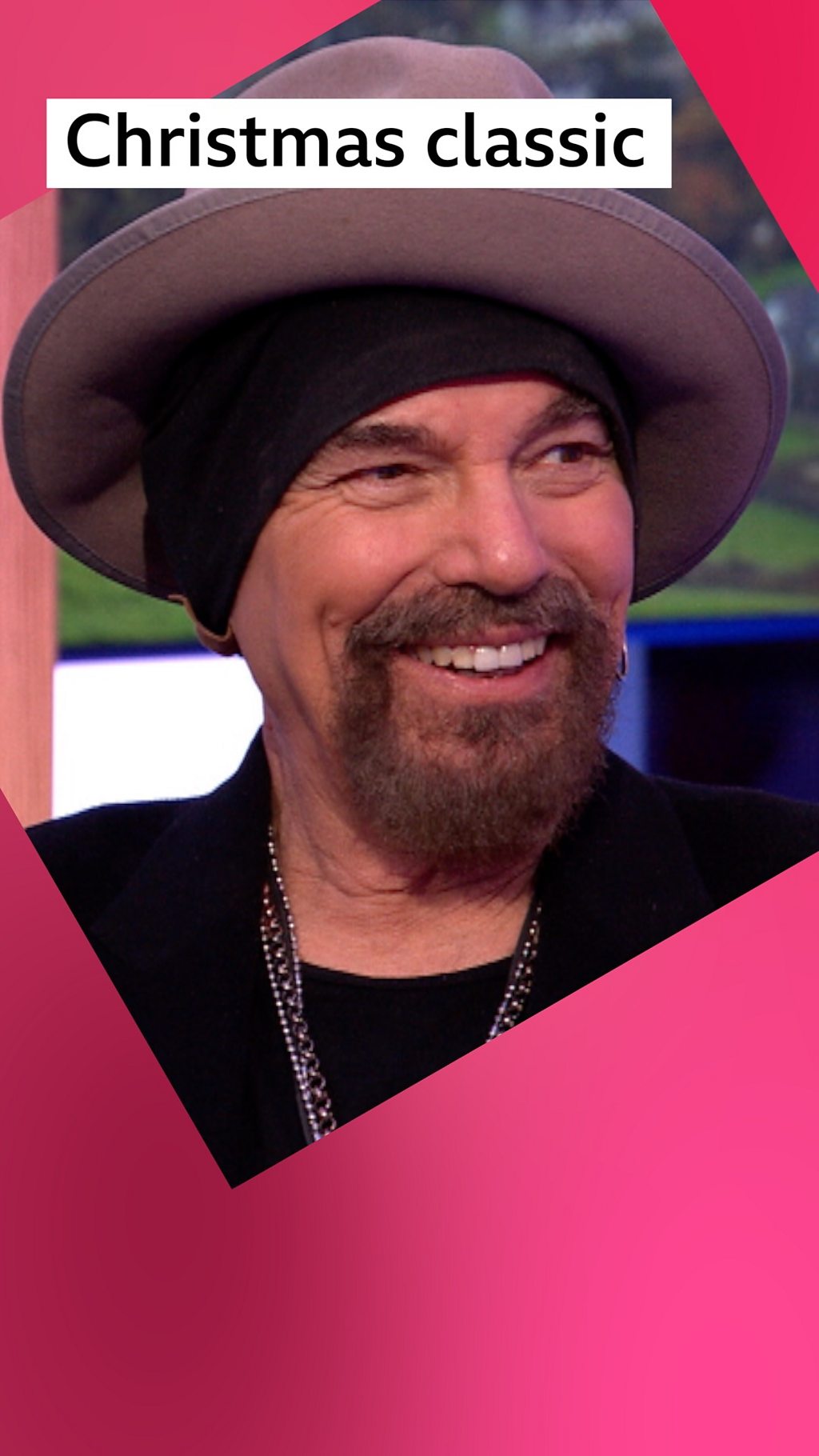 A man, Billy Bob Thornton, smiles - he has a brown beard and wears a round hat