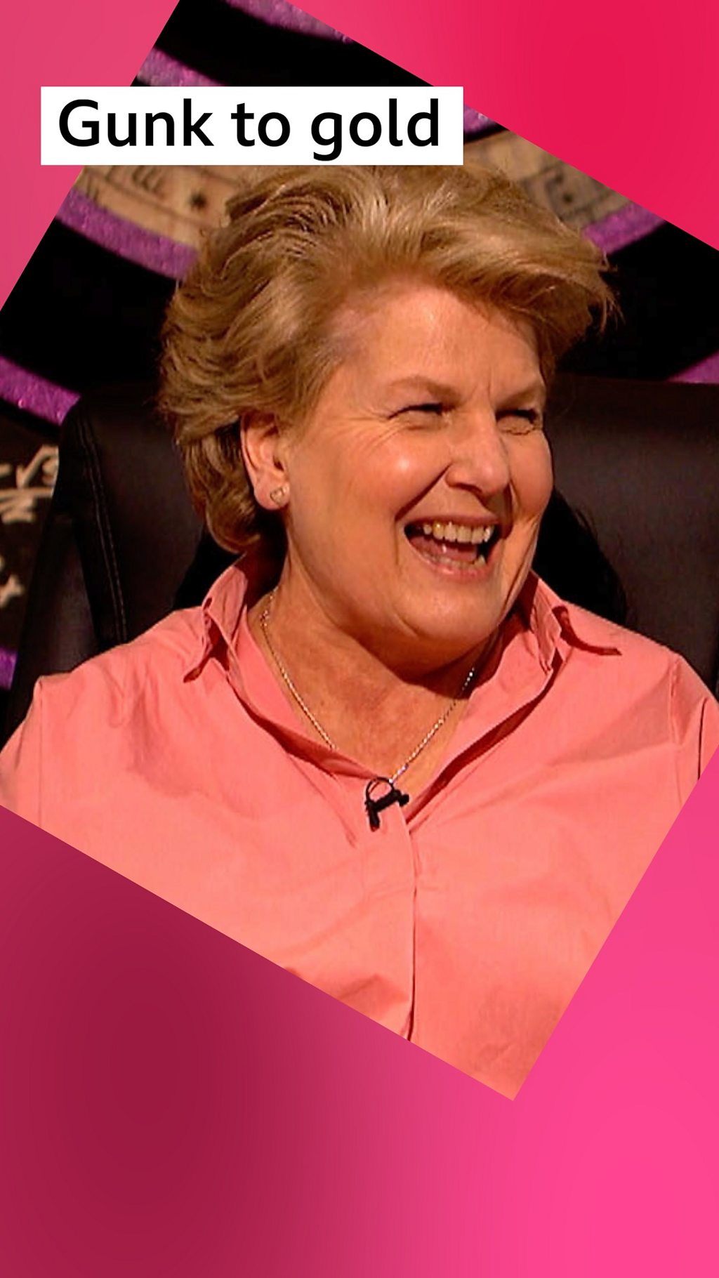 Sandi Toksvig, host of QI, wearing a pink shirt and laughing. Label text: Gunk to gold