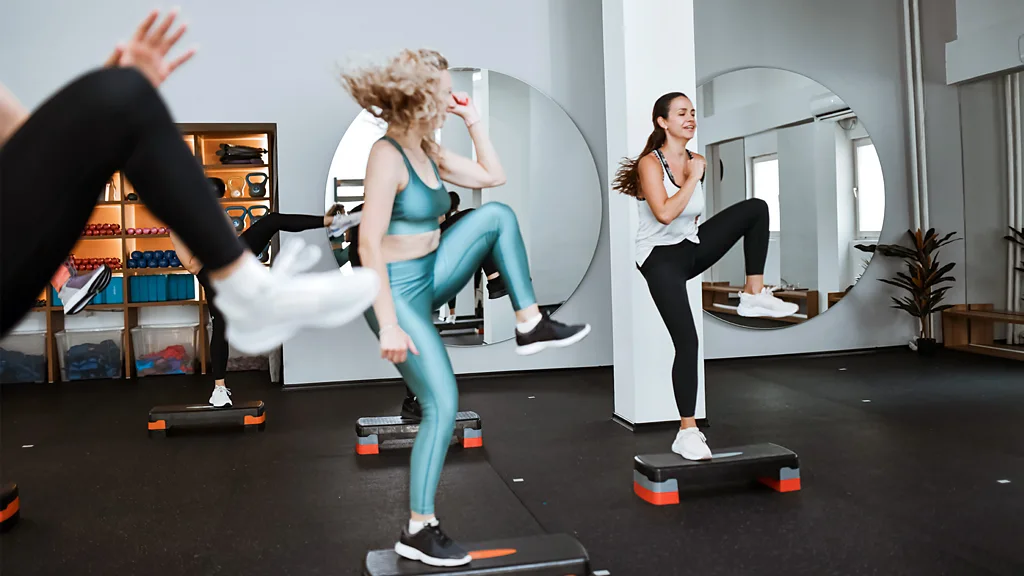 Three women high-fiving in gym (Credit: Getty Images)