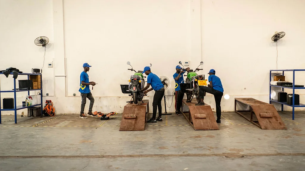 Workers at the startup Spiro service the company's e-bikes