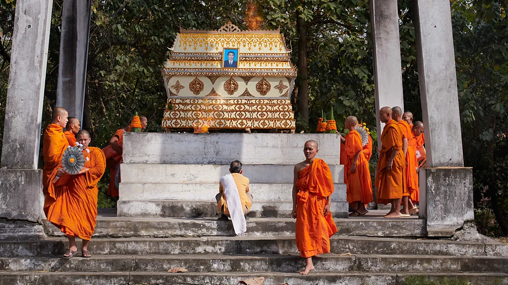 Monks in front of a temple in Laos (Credit: Simon Urwin)