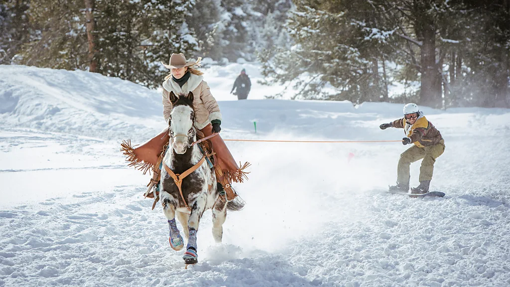 Away from race day crowds, skijoring is also practiced in controlled settings where riders, horses and skiers train together at slower speeds (Credit: Keely Jackson)