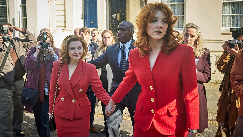 A still from Young Sherlock, showing a man in a suit in front of a horse and cart