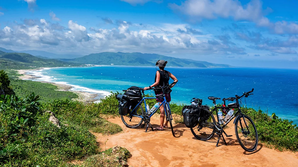 A cyclist rides along a coastal road in Taiwan's Kenting National Park (Credit: Getty Images)