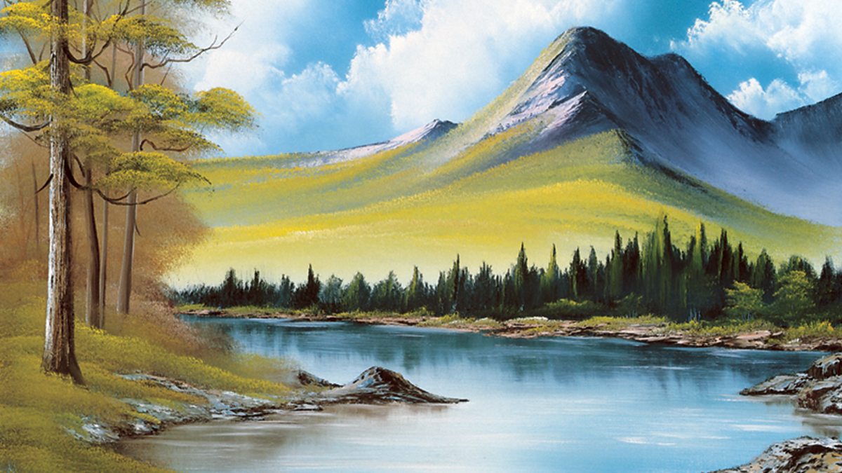 Bob Ross paints a mountain scene, featuring a crystal lake and rocky banks....