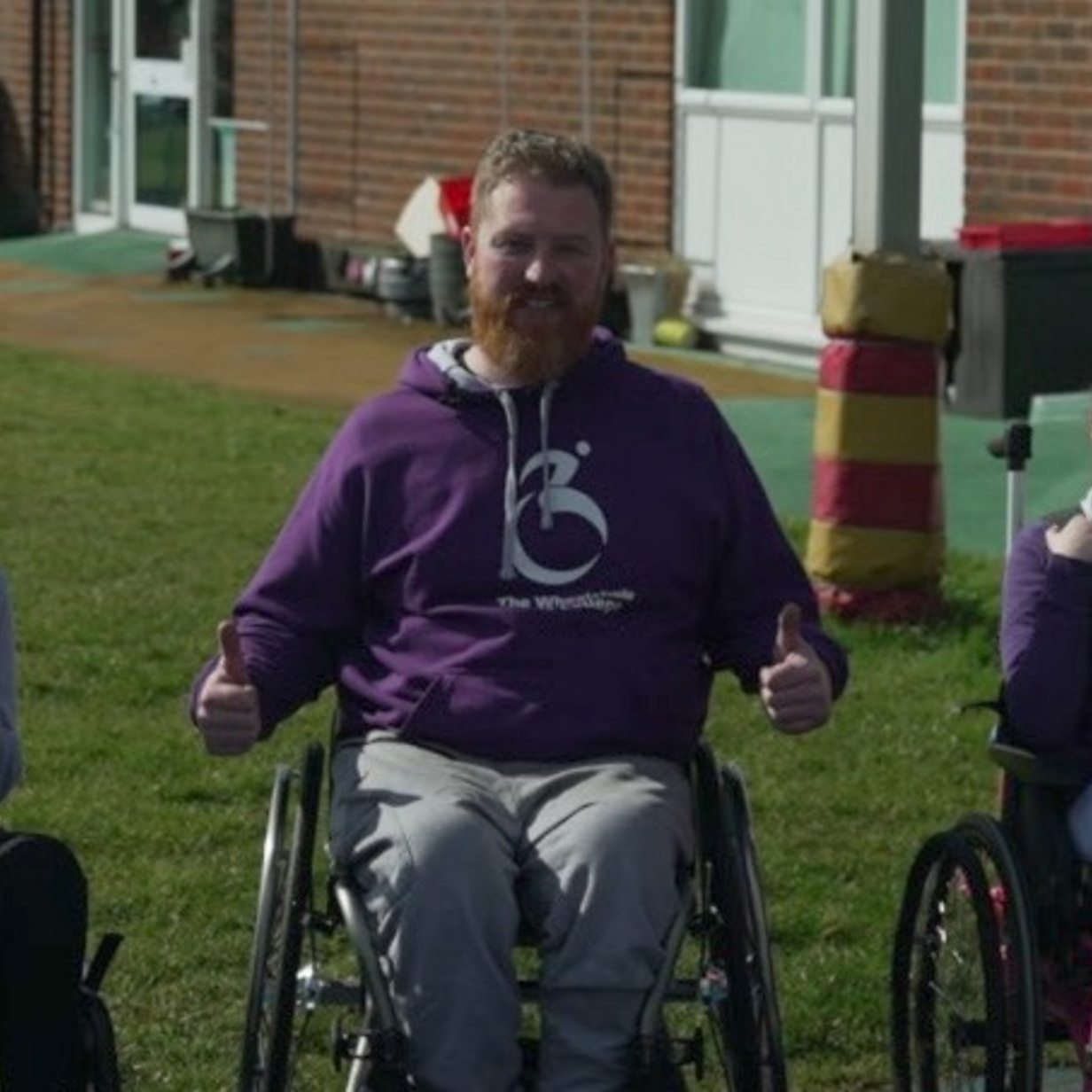 The man teaching children how to use wheelchairs