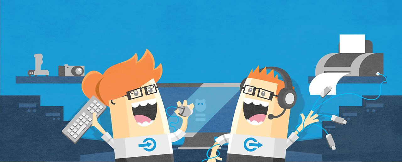 Two happy computer scientists are surrounded by technological devices.