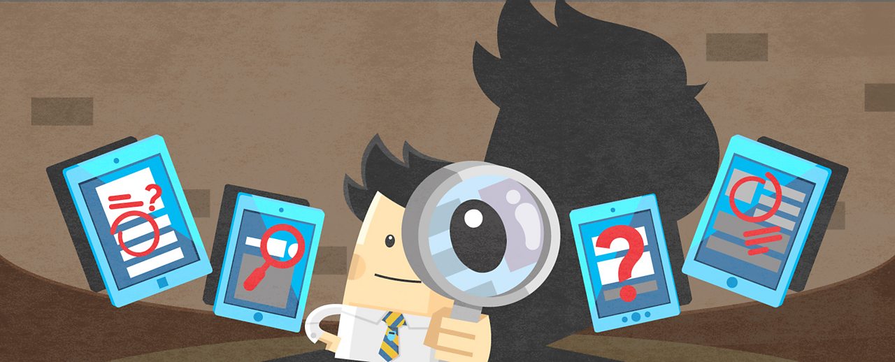 A boy looking through a magnifying glass at a computer screen.