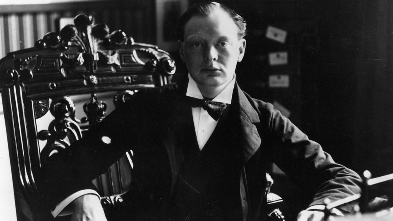 Winston Churchill seated at his desk after becoming MP for Oldham.