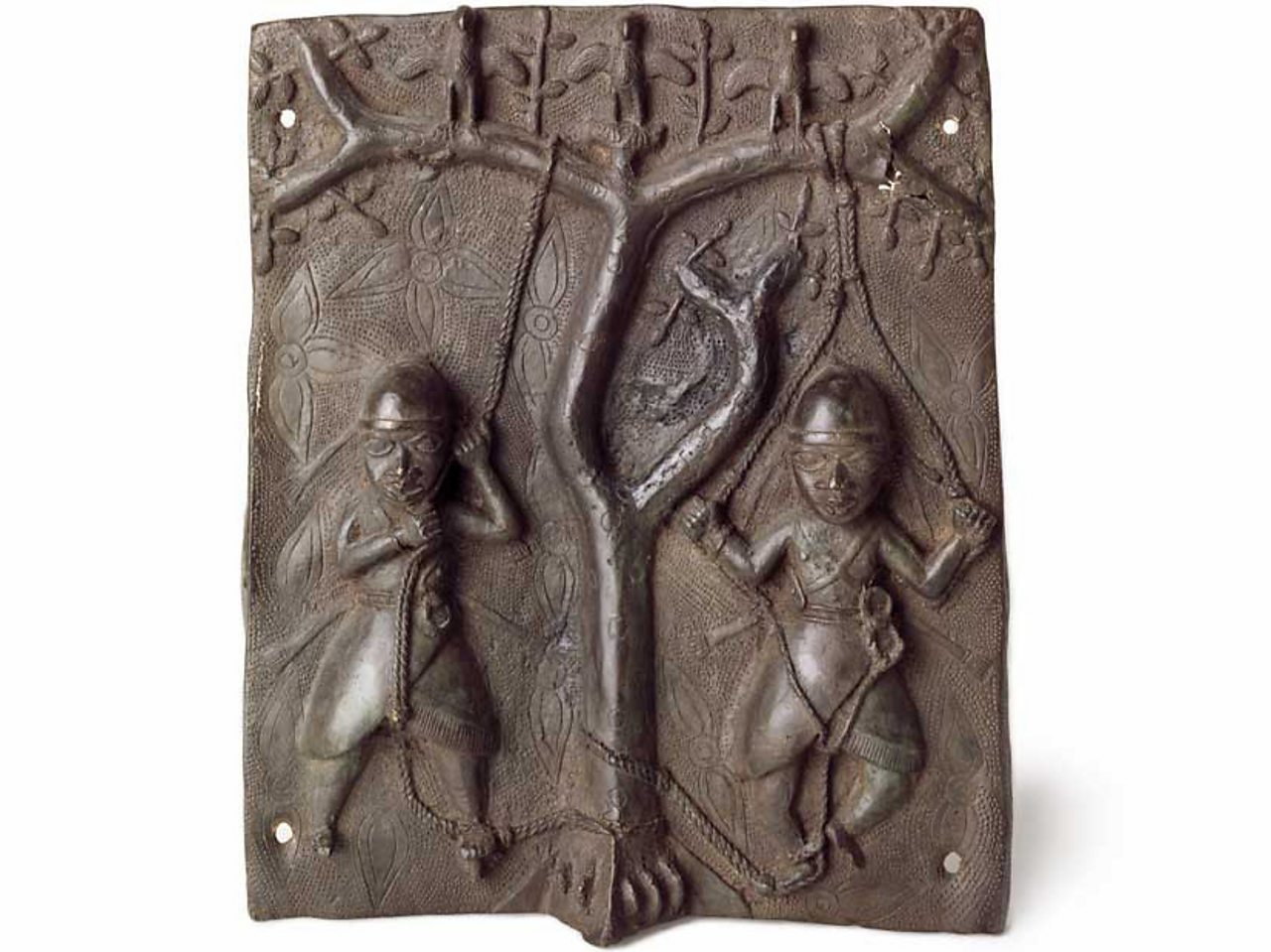 A brass plaque showing acrobats