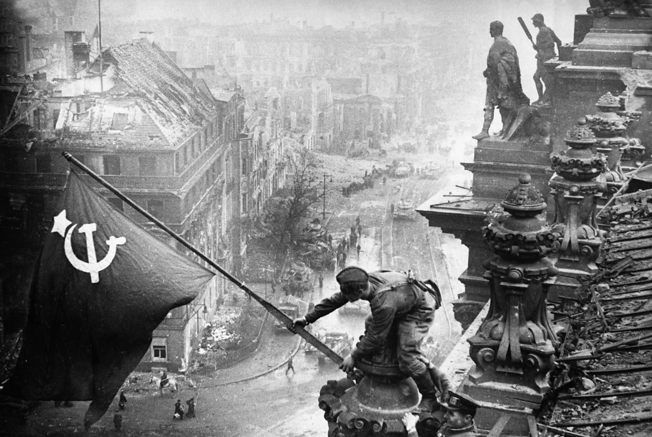 Red Army soldiers raise the Soviet flag over the Reichstag in Berlin on 30 April.