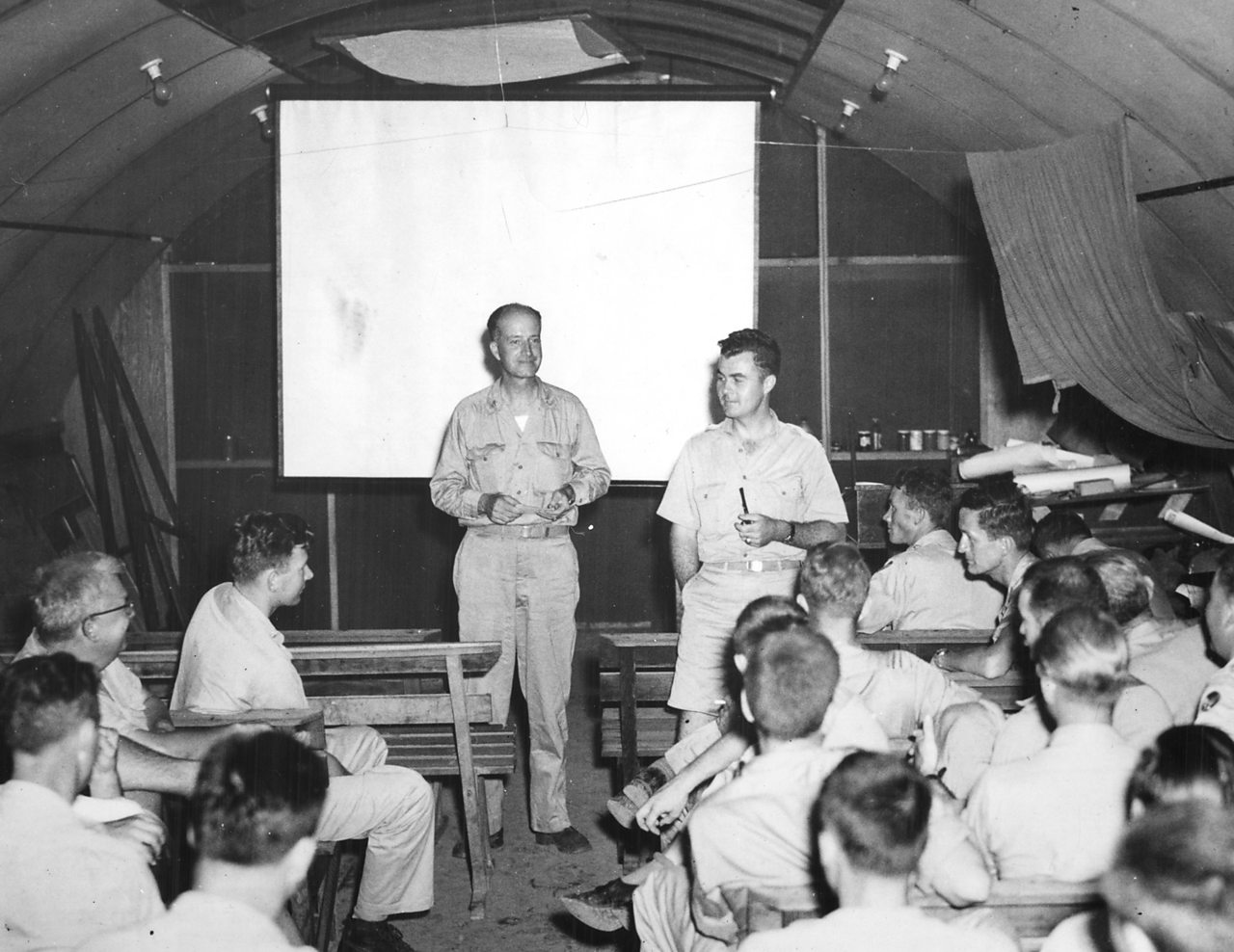 Captain Parsons and Paul Tibbets address their crews ahead of the mission.