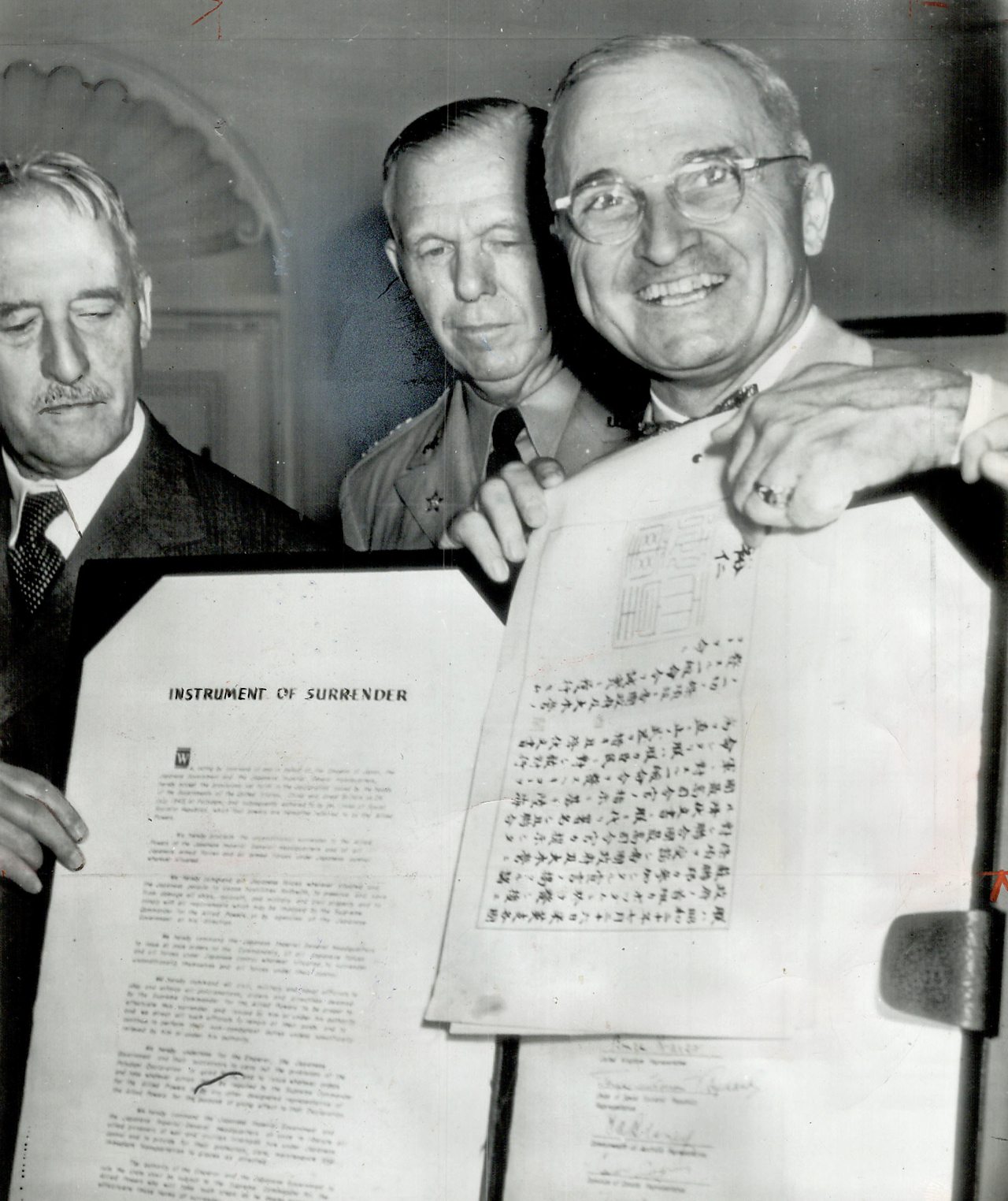 President Truman indicating Hirohito's signature, authorising Japan's surrender.