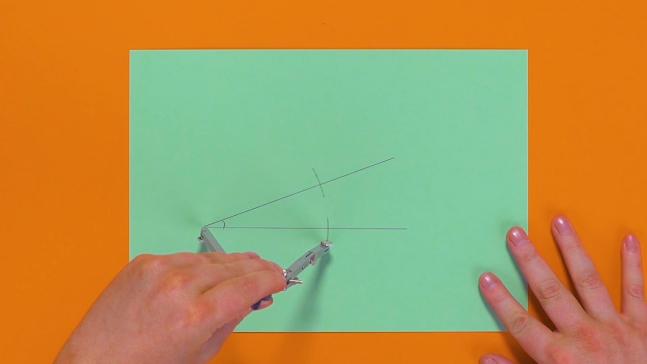 Two small points being drawn across the two lines of the acute angle