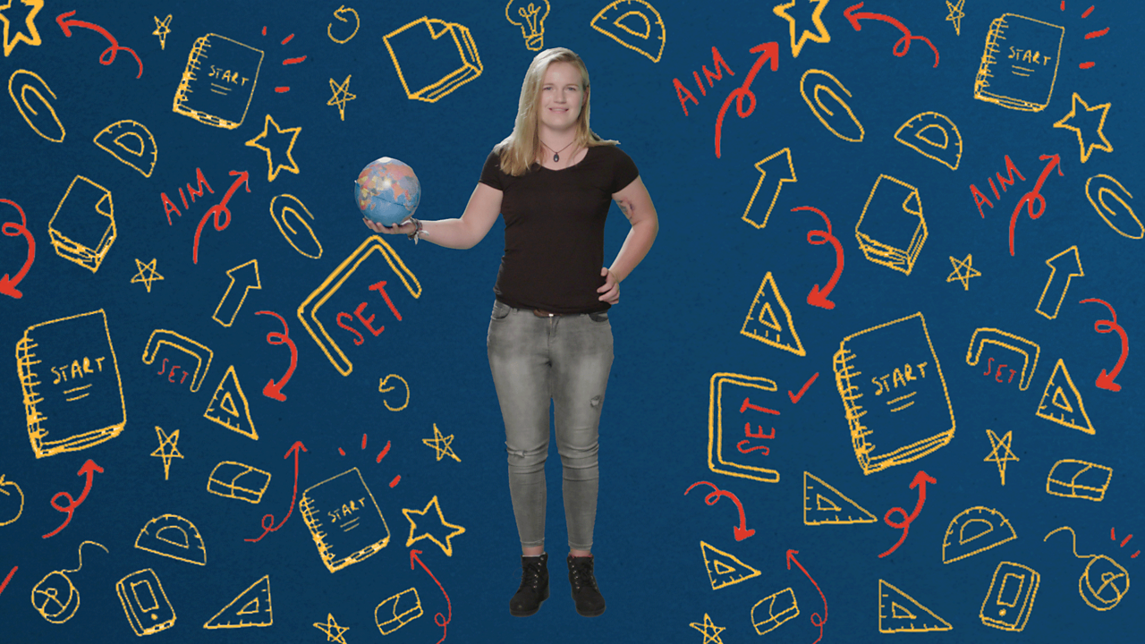 A young woman stands holding a model globe