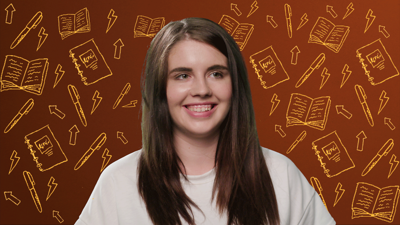 A young woman sits looking directly at the camera
