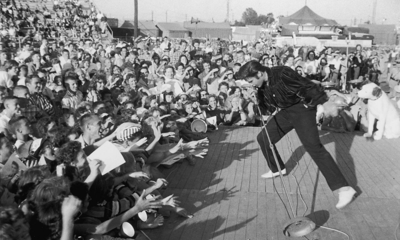 Elvis Presley performs to adoring fans in his hometown of Tupelo, Mississippi, 1957.