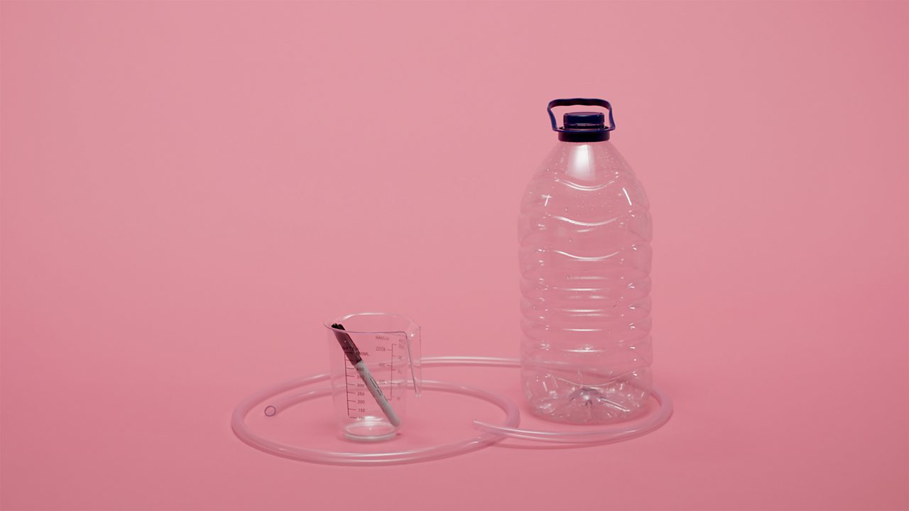 Measuring jug, large plastic bottle, pen and rubber tubing