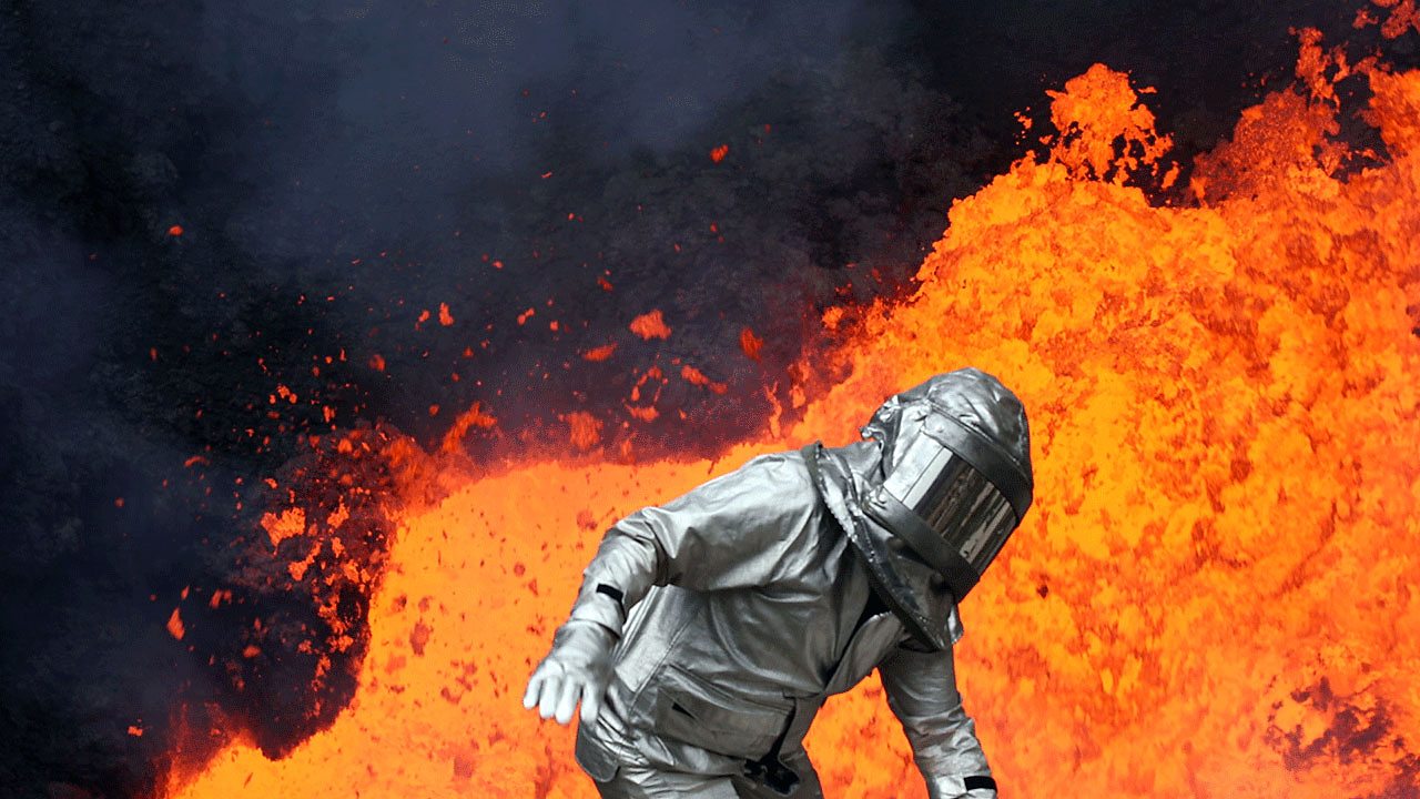 A figure in a safety suit in front of molten lava.
