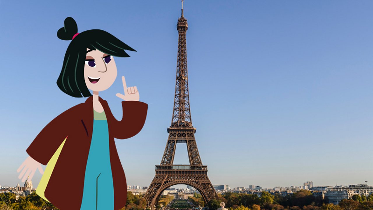 A girl standing next to the Eiffel Tower in Paris