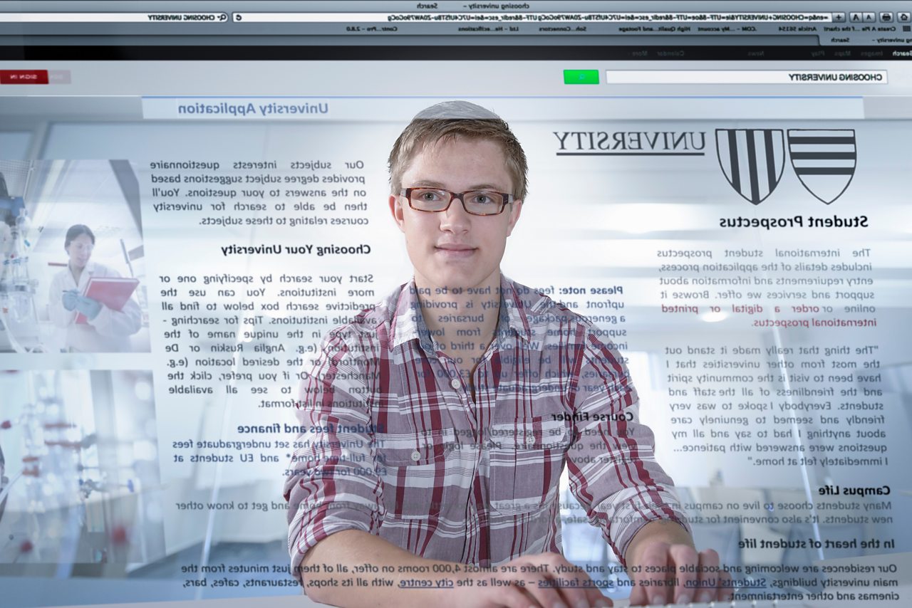 A student views University details, reflected back at him from a computer screen