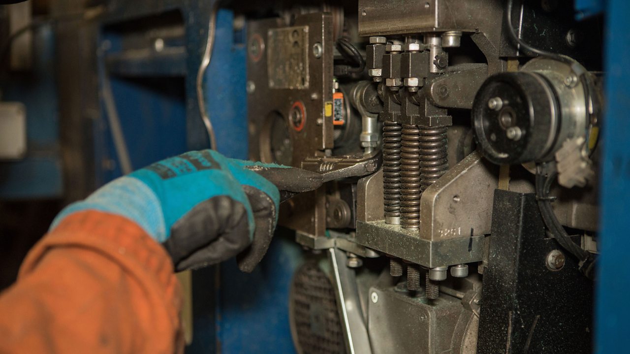 Jack fixes a machine at work.