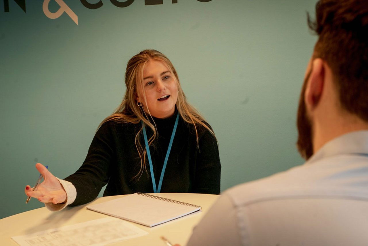 Emily talking to a client