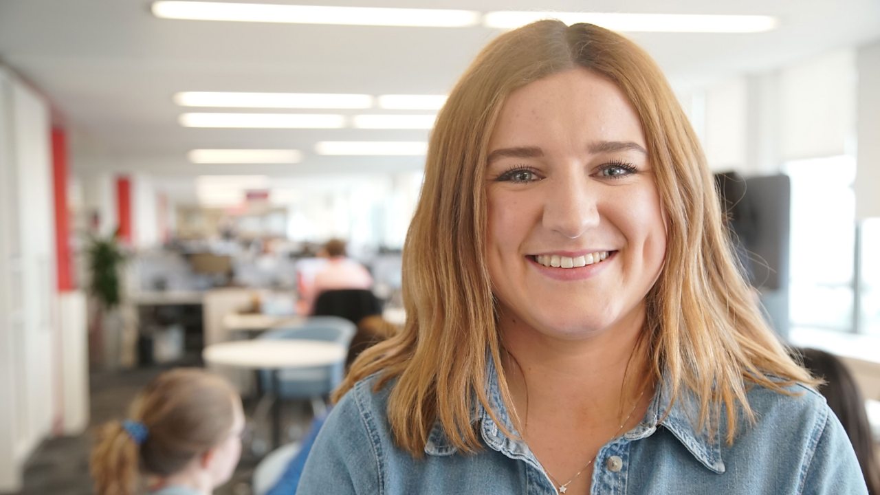 Ailish at work, smiling at the camera.