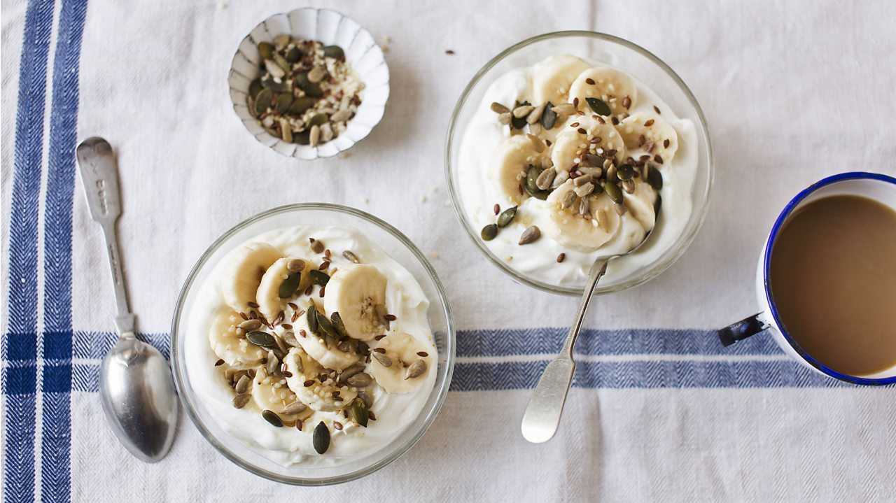 banana and seeds in yoghurt on breakfast table