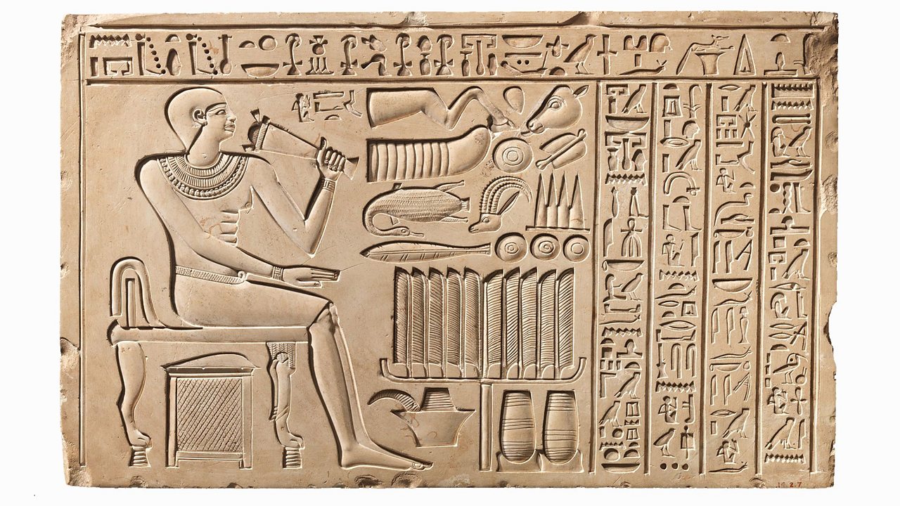 In this image an official of Pharaoh Mentuhotep II called Maati sits in front of an offering table. It looks like a carving related to a funeral because the table is a stand with tall leaves. Food offerings float above the table and below it is a basin for Maati to wash himself. The hieroglyph text on the right are traditional passages carved to commemorate the dead.