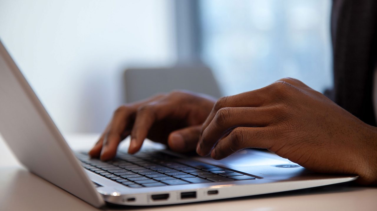 Bode at work, typing on a laptop.