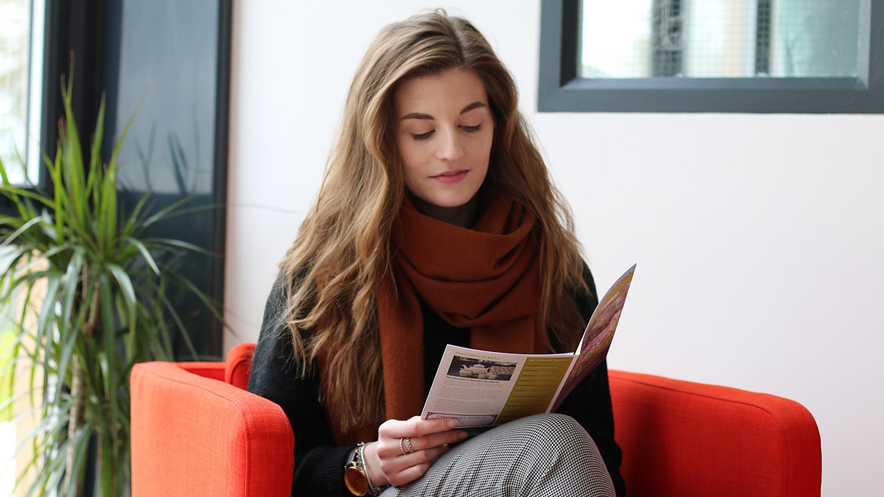 Alex reading a leaflet.