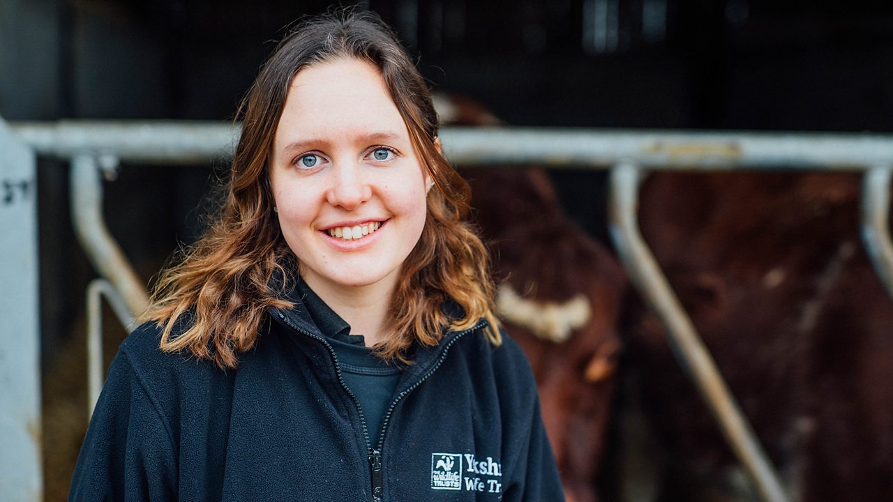 Lorna on the farm, smiling at the camera.