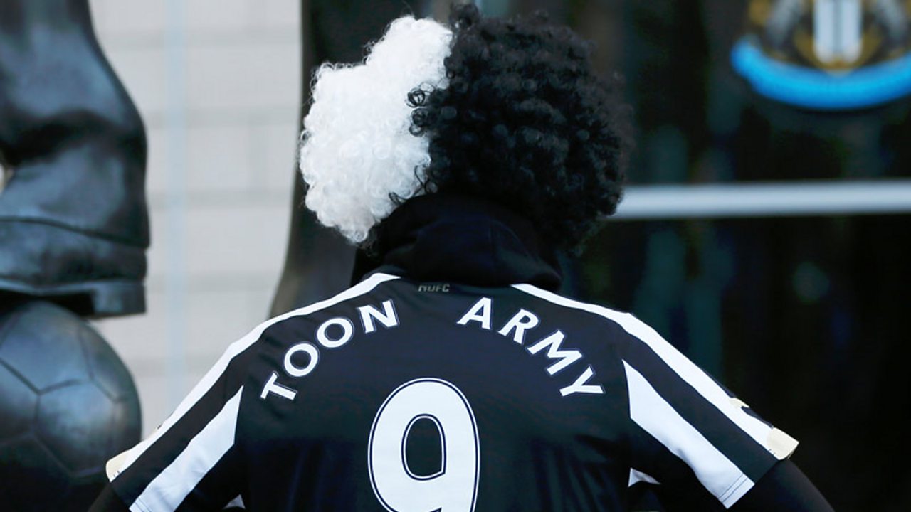A Newcastle fan wearing a top saying "toon army"
