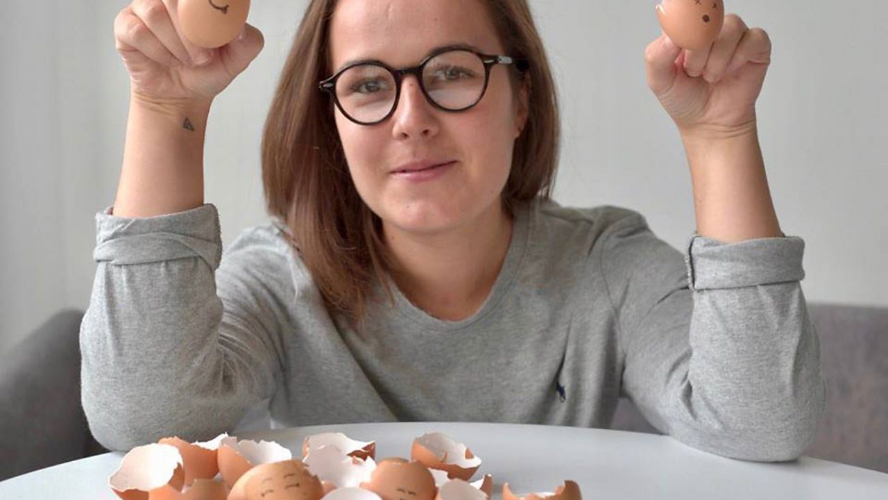 Lara holding two eggs.