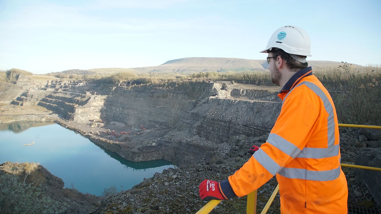 Alex looking out over a quarry at work.