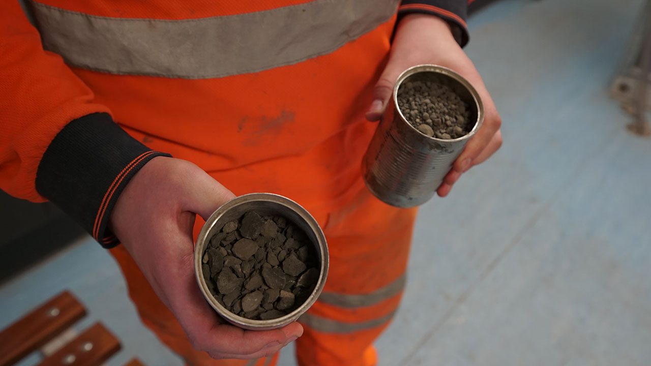 Alex holding rock samples.