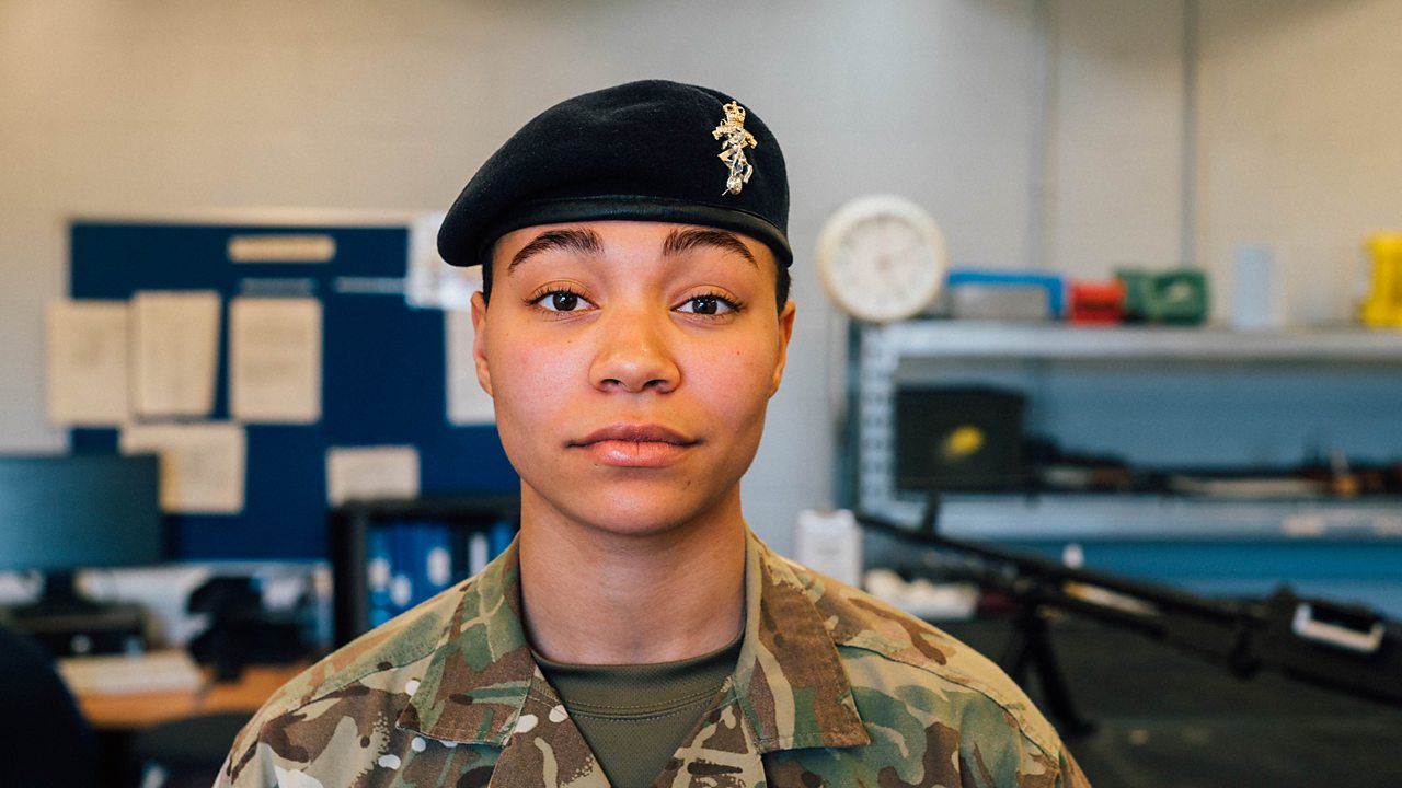 Naomi in her army uniform, looking directly at the camera.