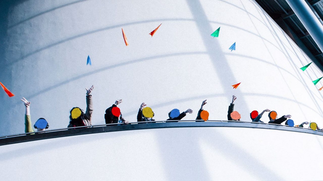 An image of people throwing colourful paper planes into the air.