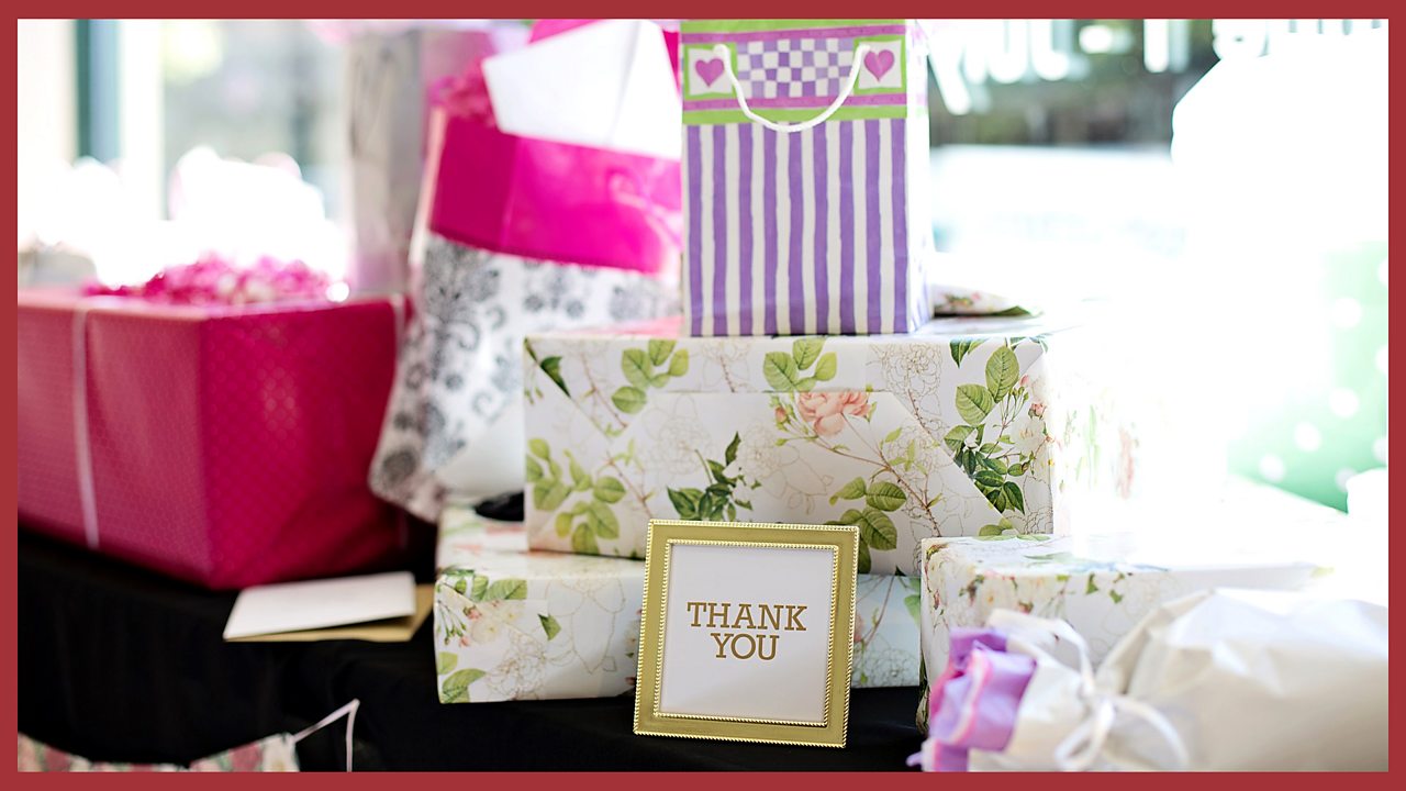 An image of gift-wrapped boxes and gift bags with a sign saying "thank you".