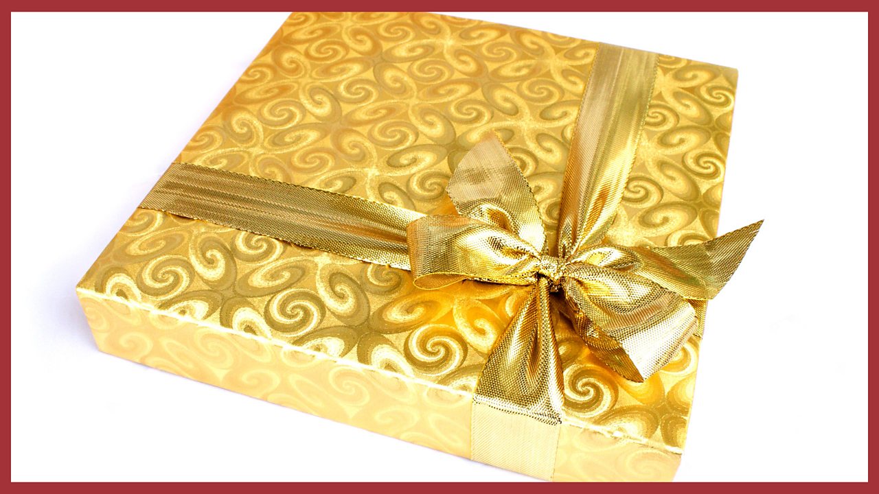 An image of a box wrapped in golden paper.