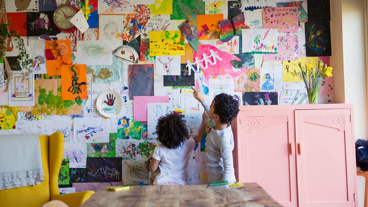 Siblings looking at artwork on wall
