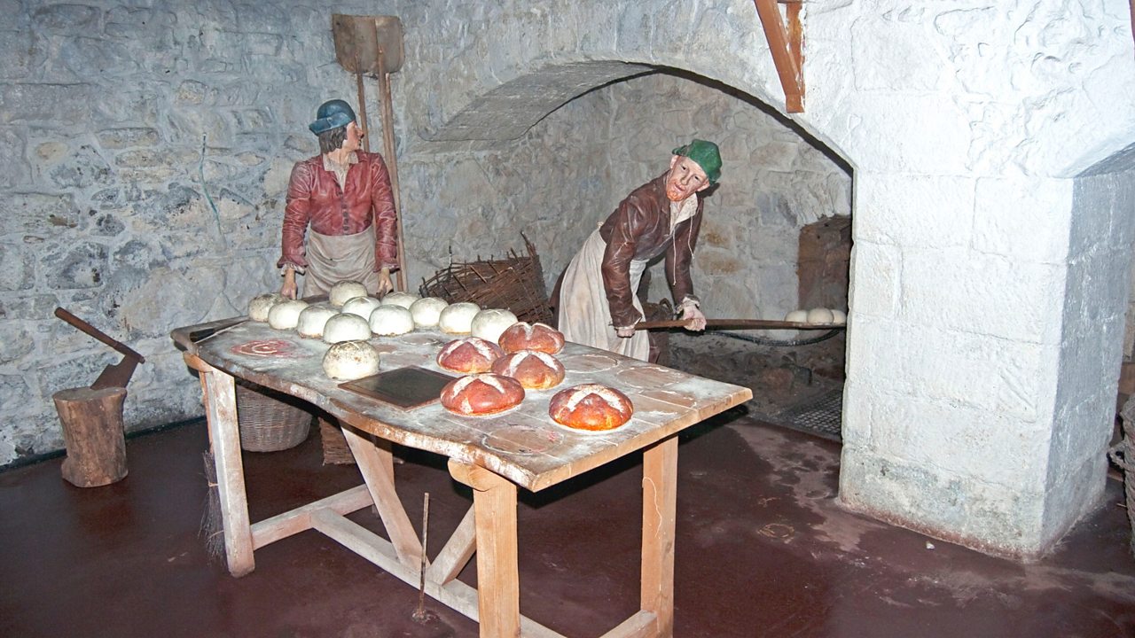 Reenactment of bread being baked in a medieval kitchen at Stirling Castle