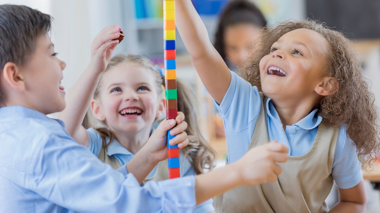 School children playing in a classroom.